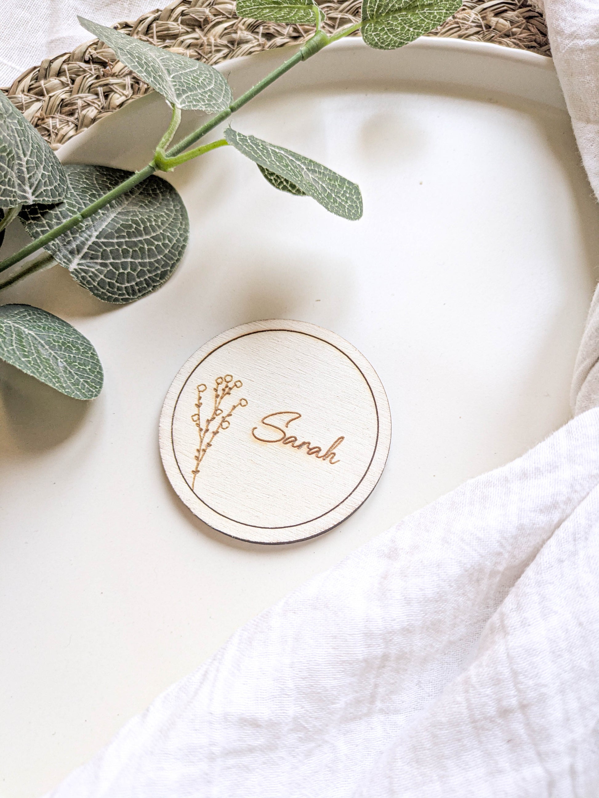Boho wedding round wooden place name on a natural table setting