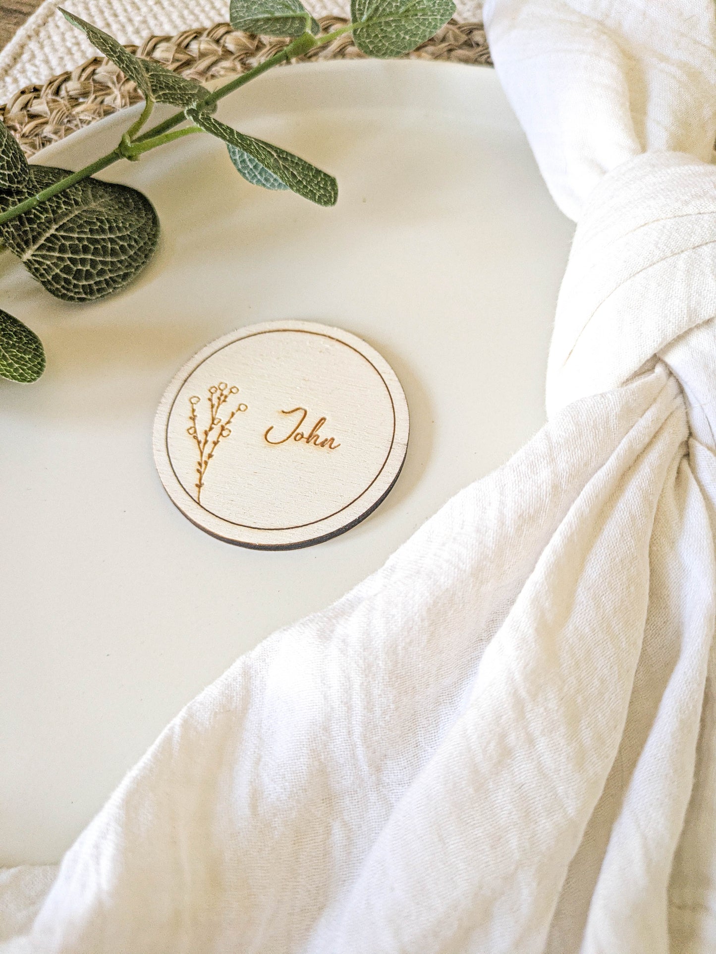 Engraved round wooden place name with Sarah design