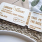 Close up of laser engraved wooden boarding pass save the date details