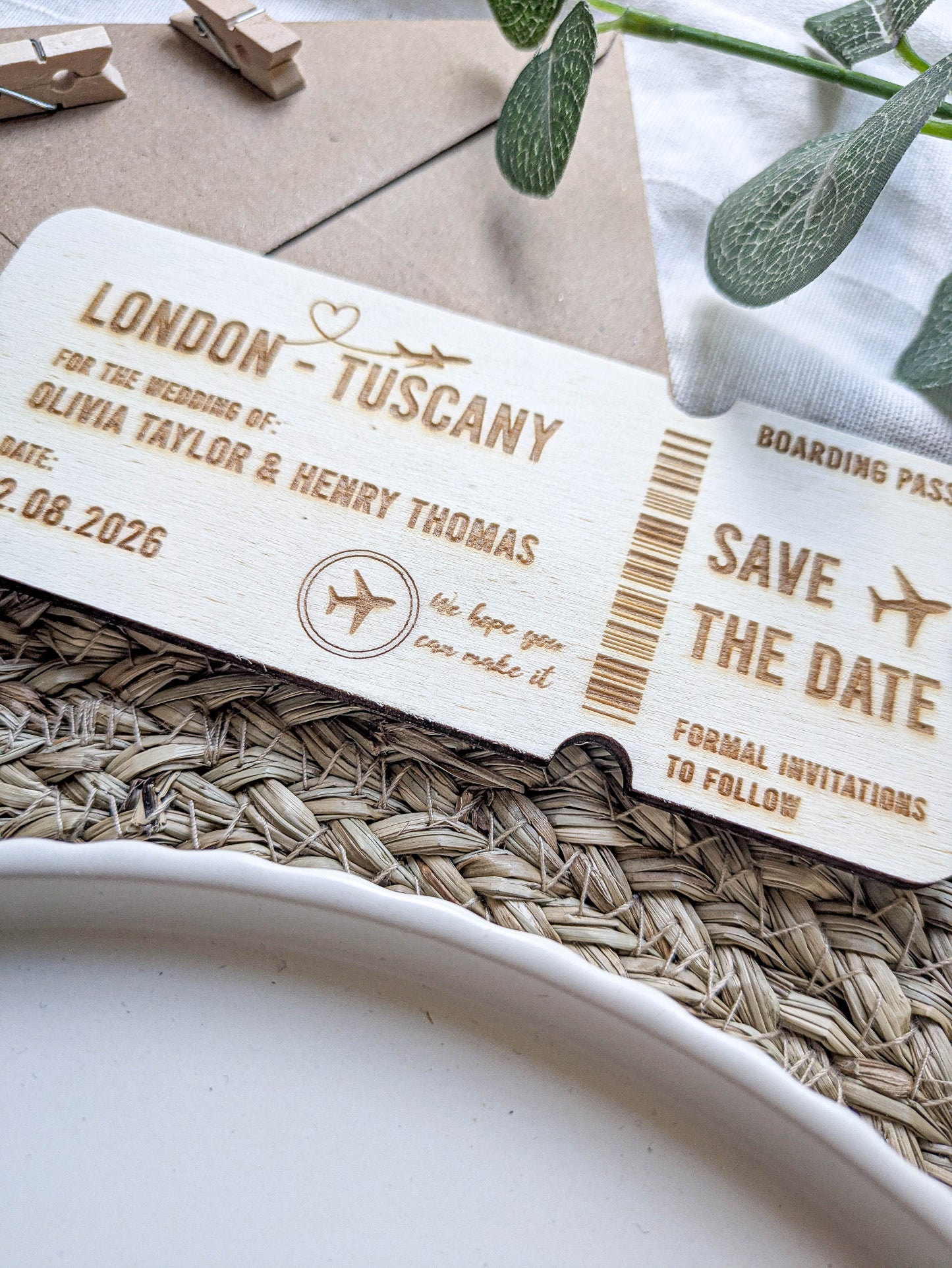 Close up of laser engraved wooden boarding pass save the date details