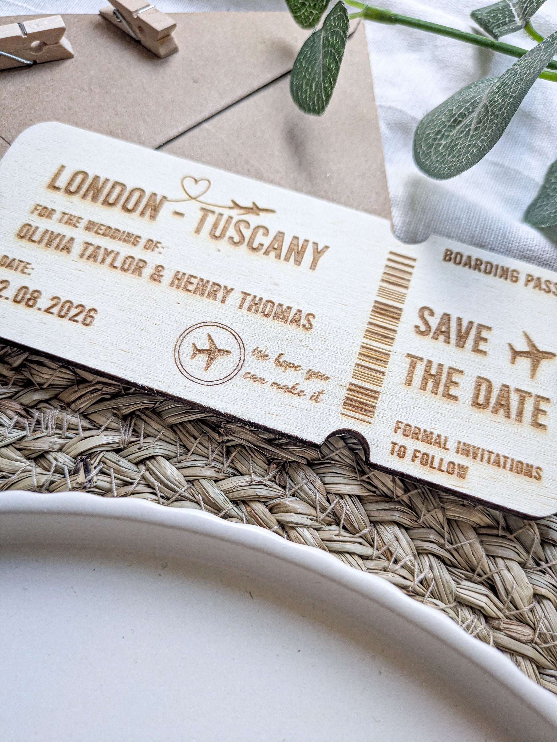 Close up of laser engraved wooden boarding pass save the date details