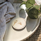 Natural wood round place name guest keepsake for a wedding table