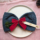 Personalised wooden Christmas present place name styled in a festive table setting; accessories not included