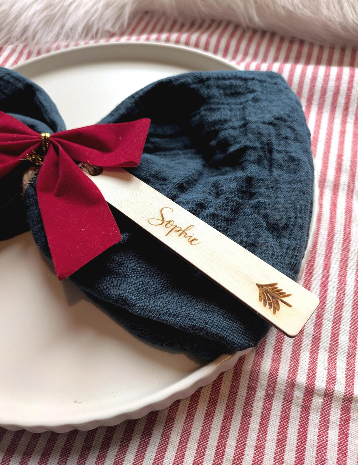 Christmas tree design: personalised wooden Christmas place name with Sophie, styled on a napkin