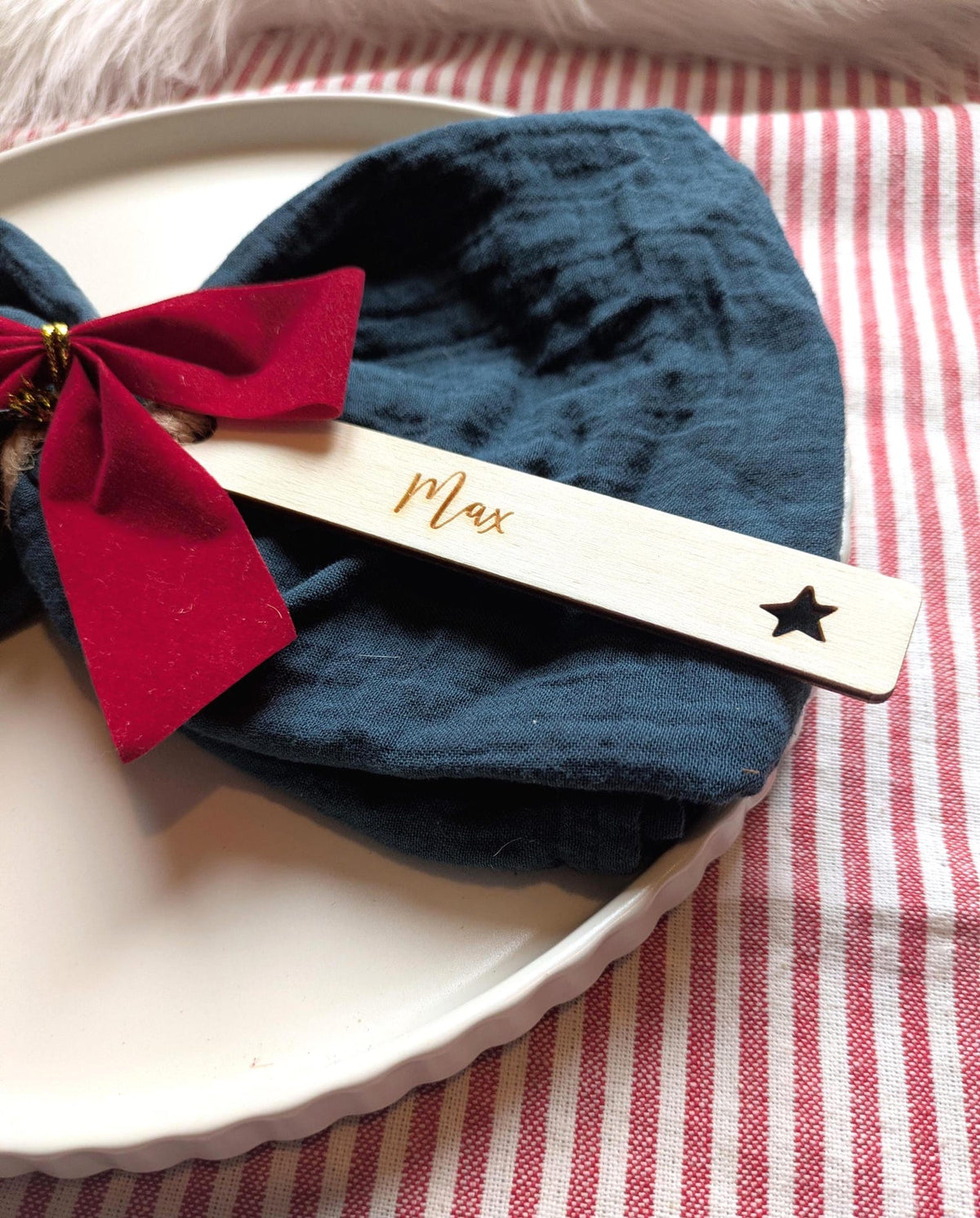 Cut out star design: personalised wooden Christmas place name with Max, styled on a napkin