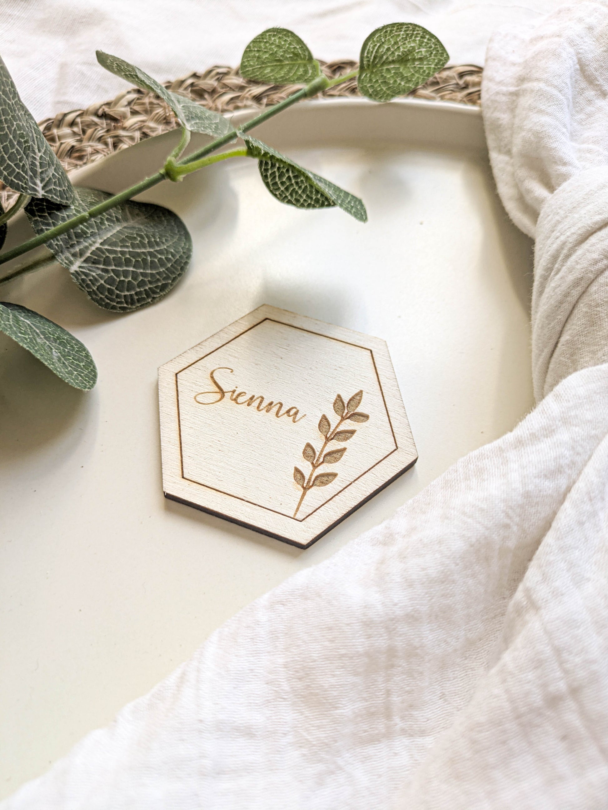 Personalised wooden hexagon wedding place name with Sienna engraving on neutral table styling