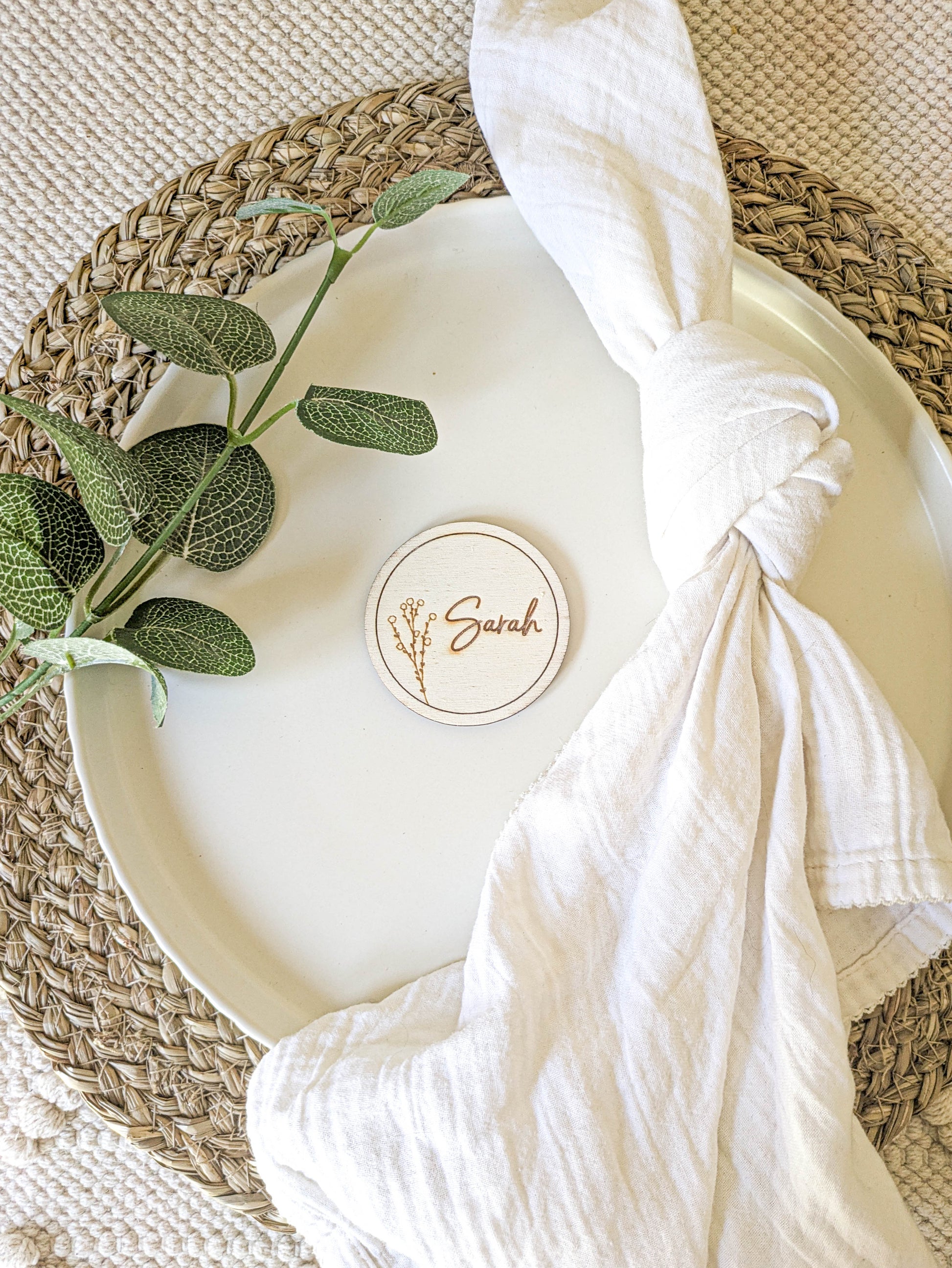 Personalised wooden round place name setting on a rustic wedding table
