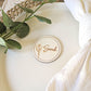 Rustic wooden place name disc styled with neutral wedding table decor