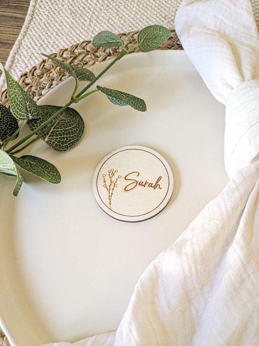 Rustic wooden place name disc styled with neutral wedding table decor