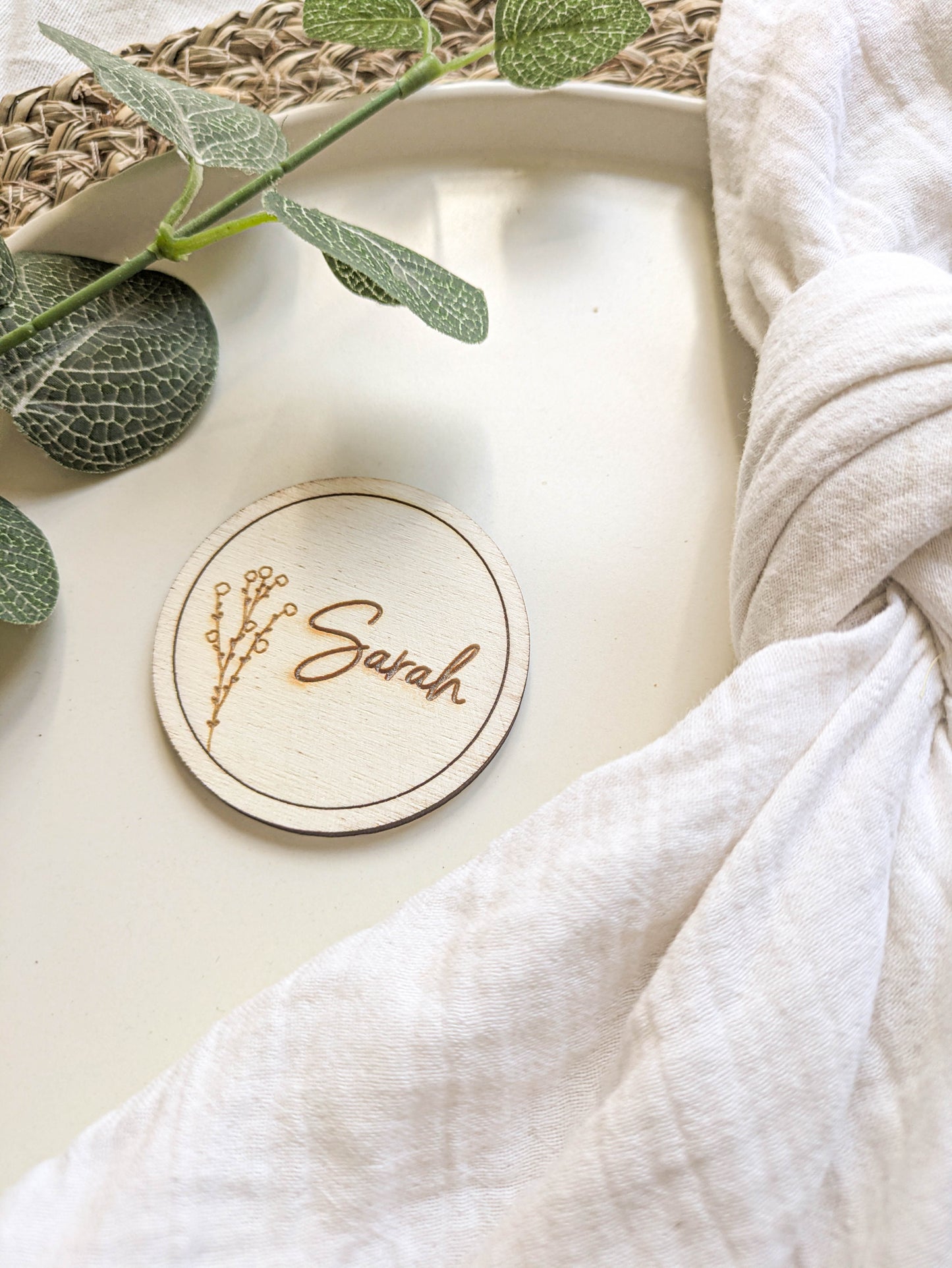 Wooden circle place name used as a personalised wedding favour