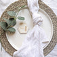 Wooden hexagon wedding place name styled on a plate with a white napkin