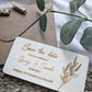 Close up of laser engraved names and date on wooden save the date card