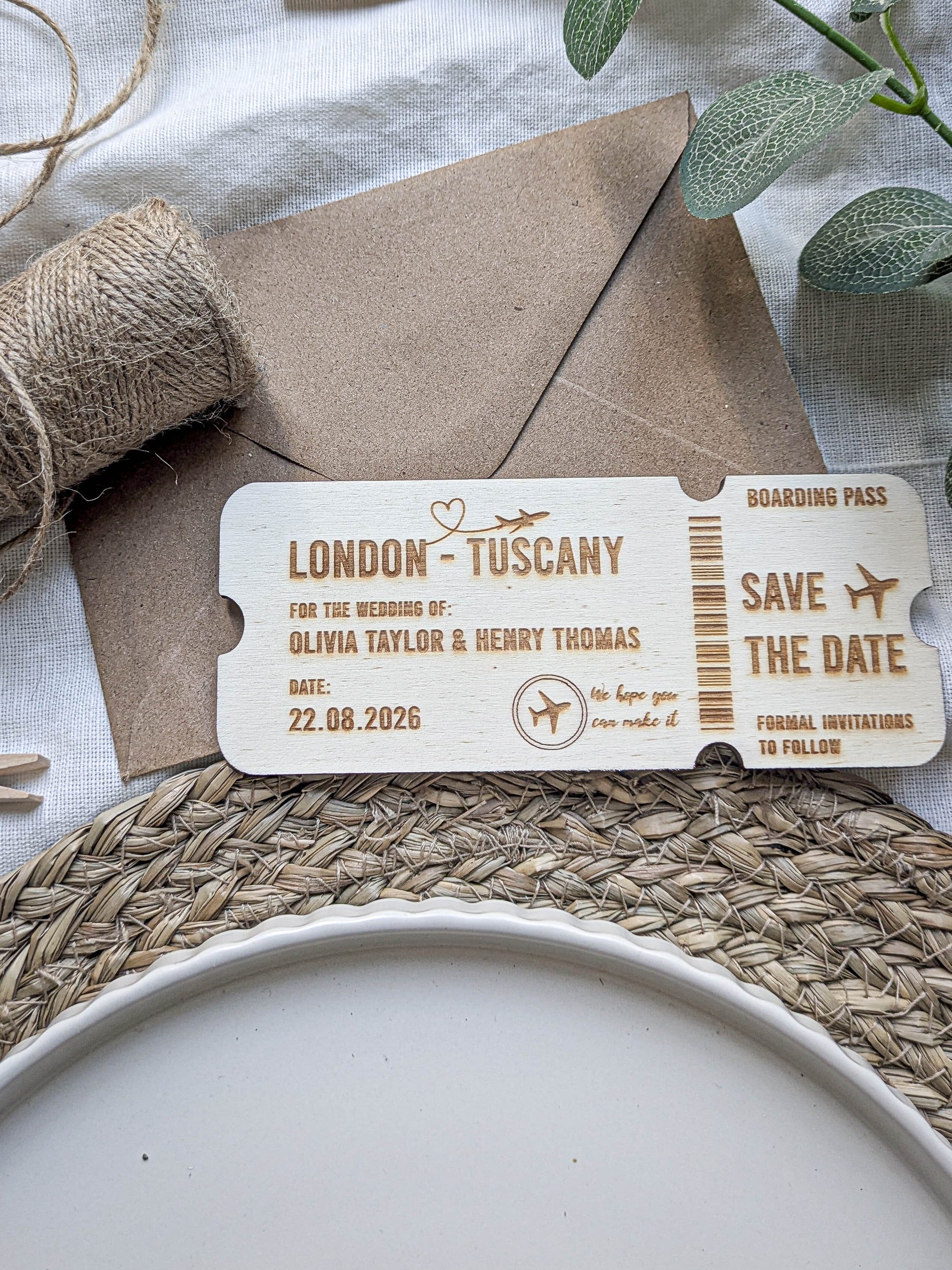 Wooden save the date ticket showing rounded edges and engraved boarding pass details